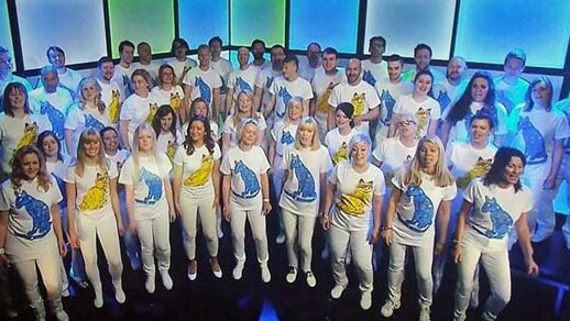 The ABBA tribute choir performs in Sweden with Tasmanian student Grace McCallum (far right, third row from front)