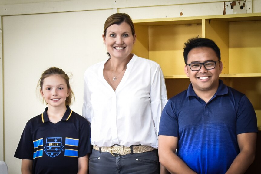 Volunteer parent and project coordinator Kate Mahoney (centre) with Father Junray Ryanga (right) at Girton Grammar School.