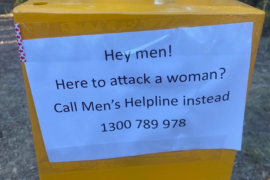 A typed sign addressing men who want to attack women, urging them to seek help