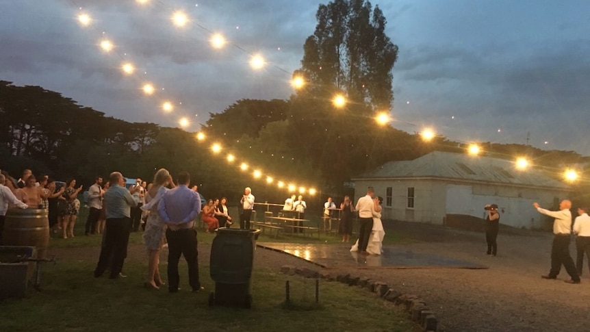 Guests watch on at the bride and groom dance at their reception at Elle Moyle's property in Gazette before the bushfire struck.