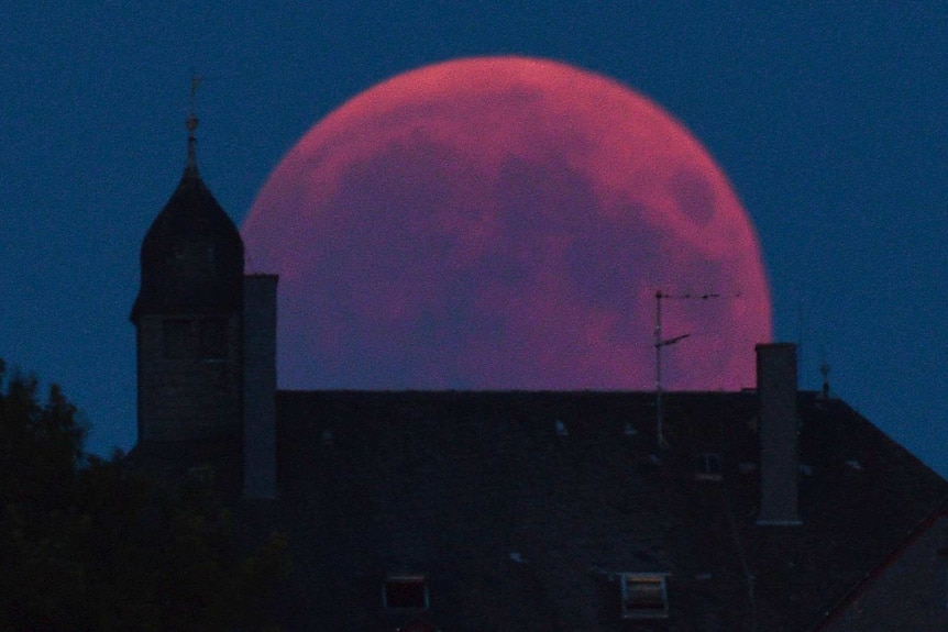 The Moon turns red during a total lunar eclipse in Bernkastel-Kues.