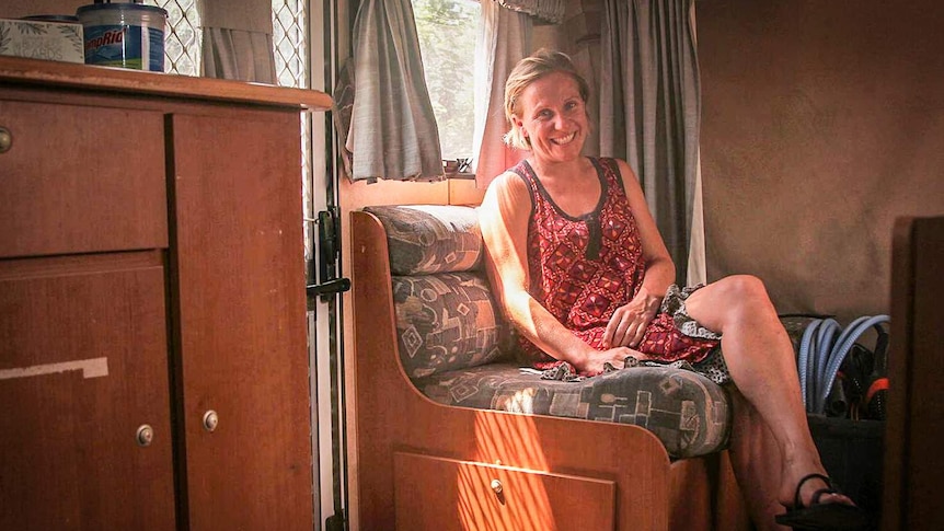 A photo of mother-of-three Katie Cross sitting inside her caravan.