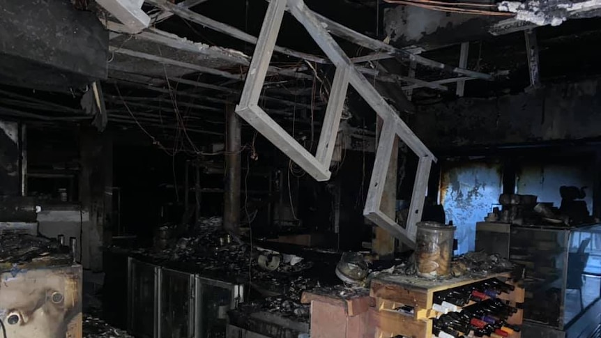 A burnt kitchen area, the roof is falling in
