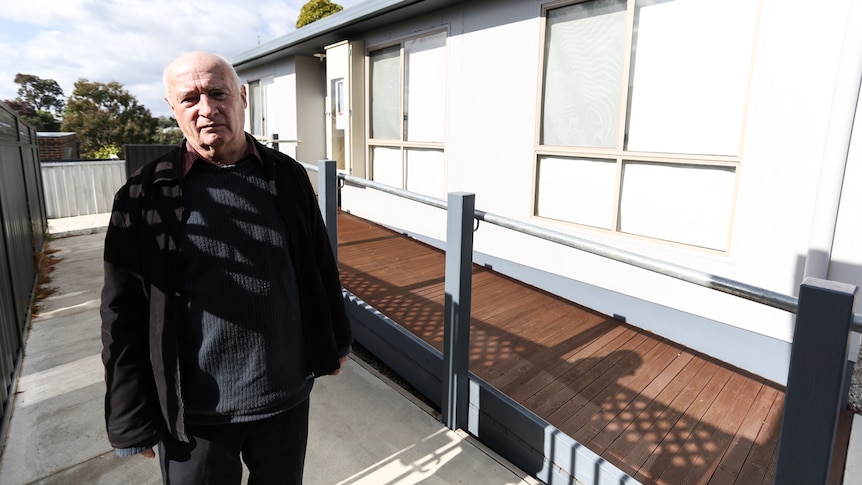 Stepfather David Coxon standing outside Warwick's unit.