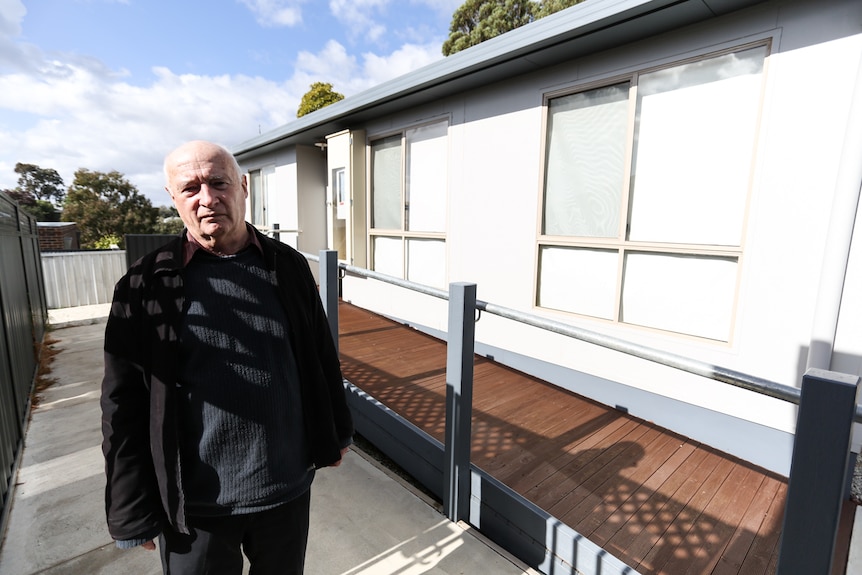 Stepfather David Coxon standing outside Warwick's unit.