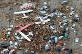 Aeroplanes lie in tsunami debris at Sendai Airport
