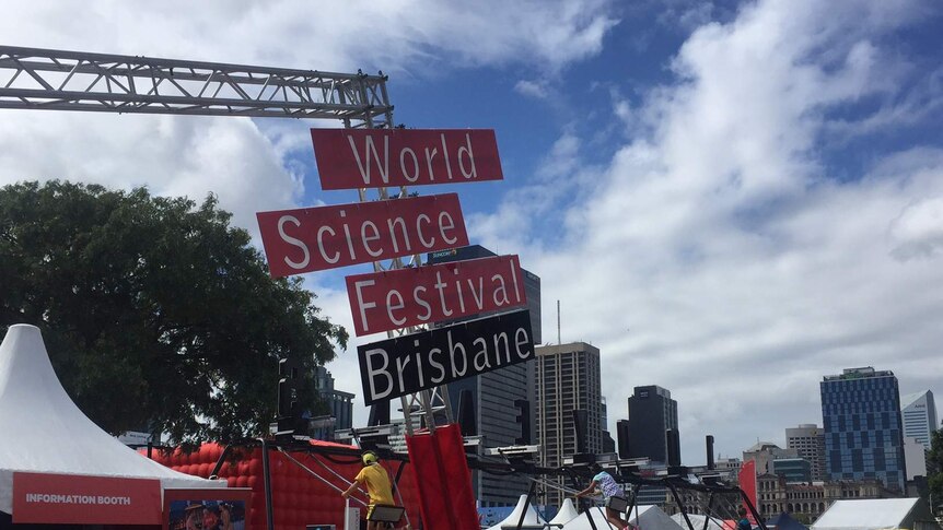 Crowds gather on a sunny day at the World Science Festival