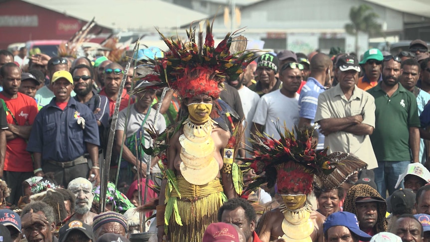 Hundreds of opposition supporters, some dressed in bright, traditional outfits.