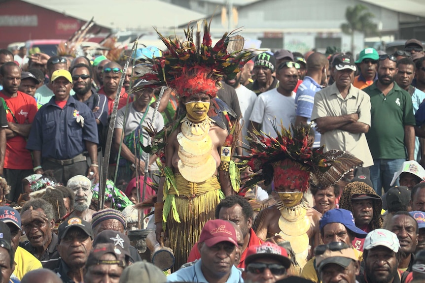 Hundreds of opposition supporters, some dressed in bright, traditional outfits.