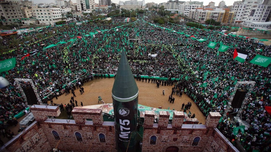 Palestinian Hamas supporters take part in a rally marking the 25th anniversary of the founding of Hamas.