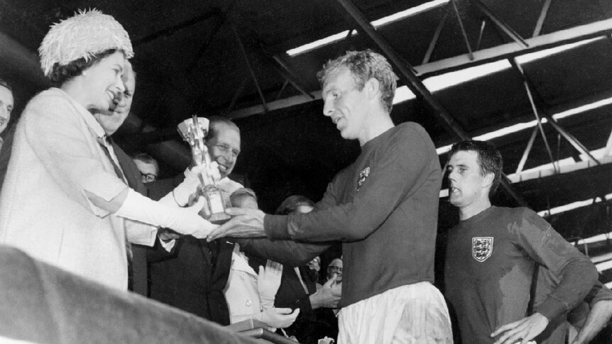Queen Elizabeth II presents the Jules Rimet Cup to Bobby Moore at the 1966 World Cup.