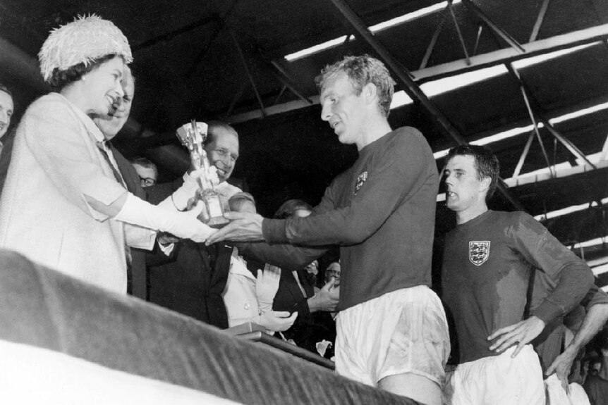 Queen Elizabeth II presents the Jules Rimet Cup to Bobby Moore at the 1966 World Cup.