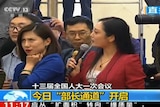 A screenshot of a Chinese television broadcast shows two women, one rolling her eyes.