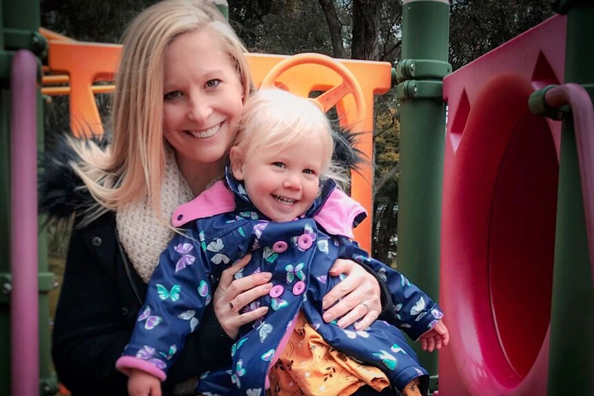 Andrea Peace on play equipment with her two year old daughter Madison