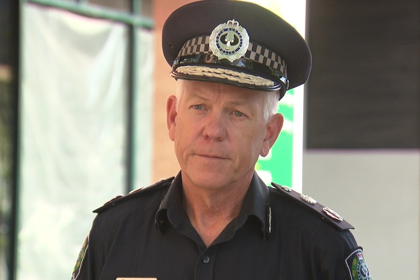 A police officer wearing a peaked cap