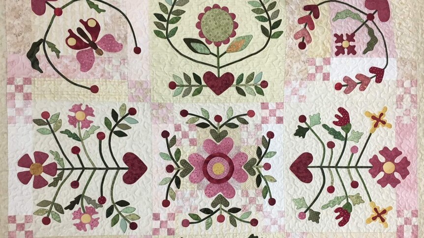 Applique style quilt with butterflies, hearts and flowers