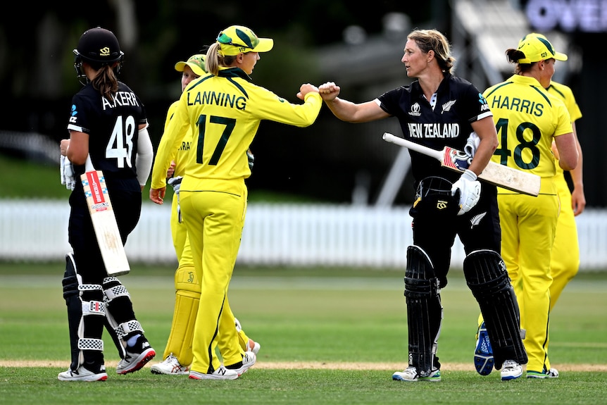 An Australian player congratulates her New Zealand counterpart after a Women's World Cup warm-up match.