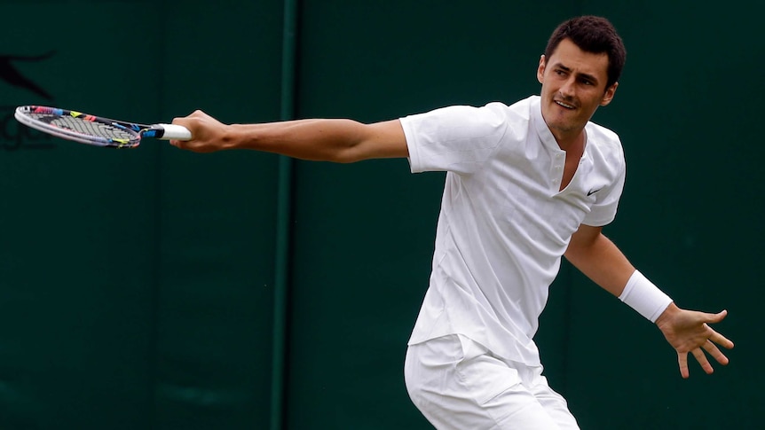 Bernard Tomic returns to Germany's Mischa Zverev during their Men's Singles Match at Wimbledon