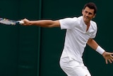 Bernard Tomic returns to Germany's Mischa Zverev during their Men's Singles Match at Wimbledon