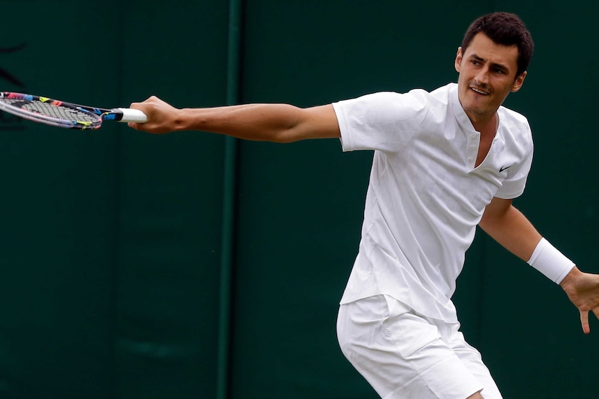 Bernard Tomic returns to Germany's Mischa Zverev during their Men's Singles Match at Wimbledon