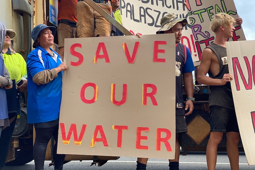 Protesters with a 'save our water' sign.