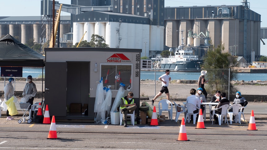 COVID testing clinic staff take a break beside the harbour.