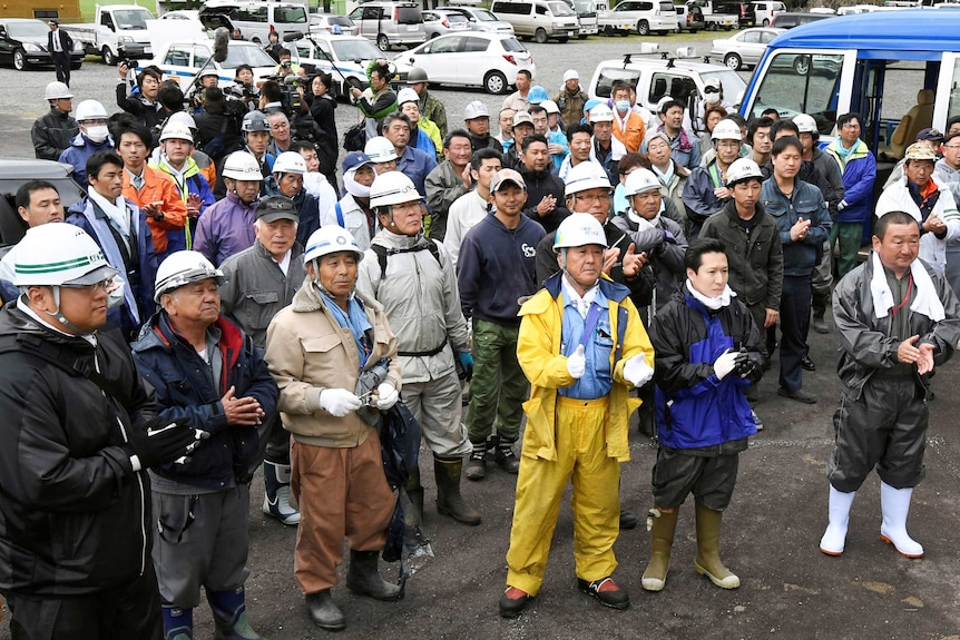 Rescuers celebrate after a seven-year-old missing Japanese boy is found alive.