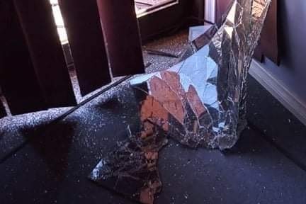 A smashed window at a music school.