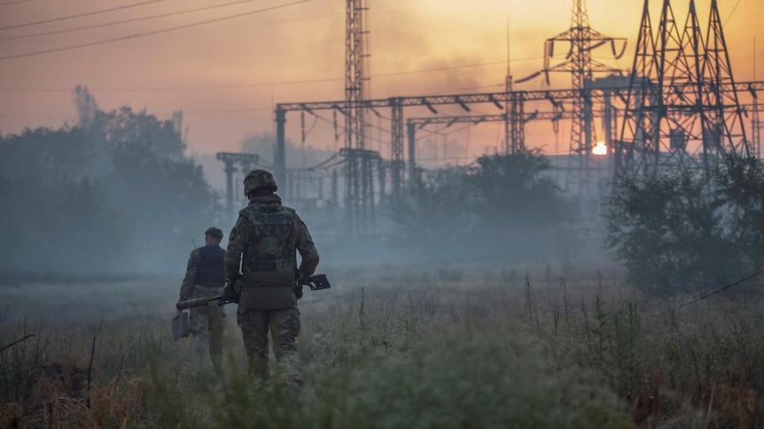 Ukrainian service members patrol an area in the city of Sievierodonetsk
