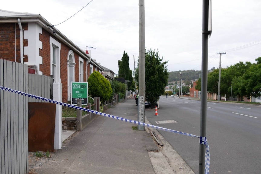 Police tape cordons off a footpath in Wellington Street, Launceston, Tasmania.