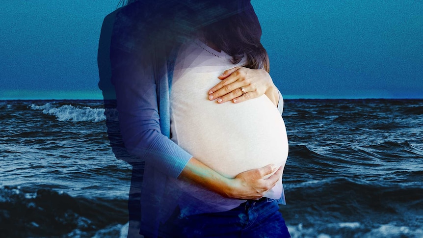 A pregnant woman standing in front of the ocean for a story about being pregnant when you have a mental illness like PTSD.