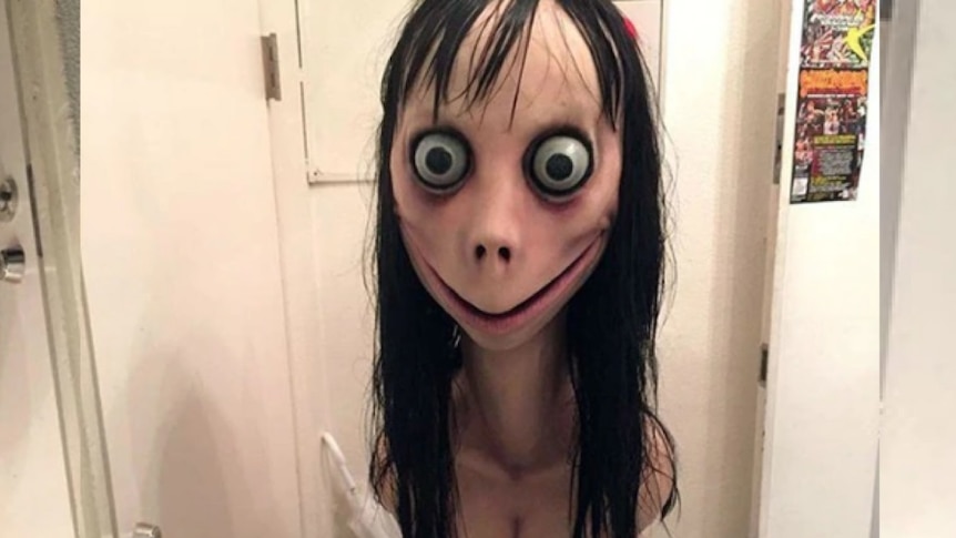 An image of the Momo Challenge, a woman with large eyes, chicken feet and breasts.
