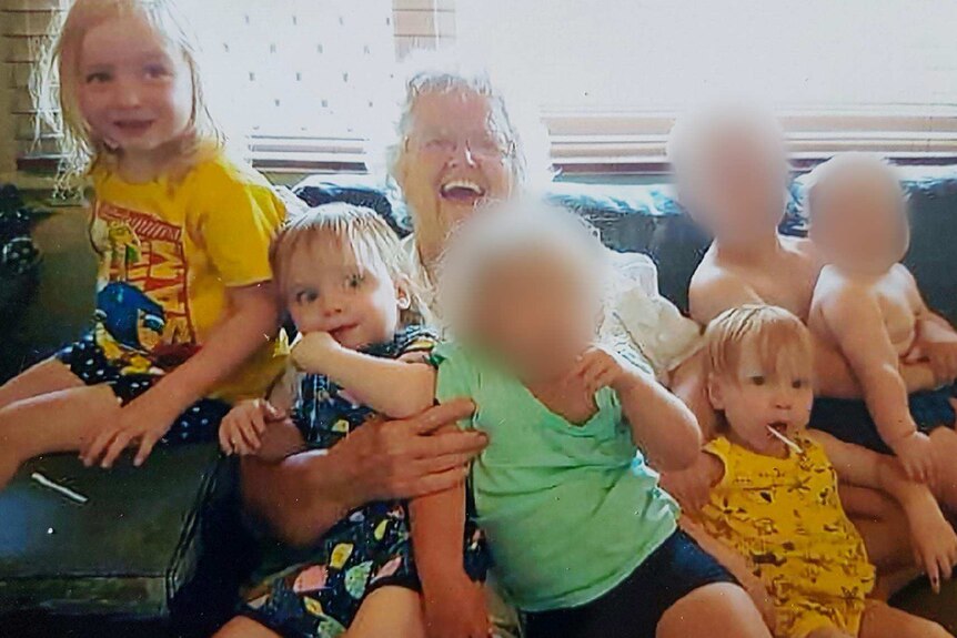 Beverley Quinn smiling with her grandchildren