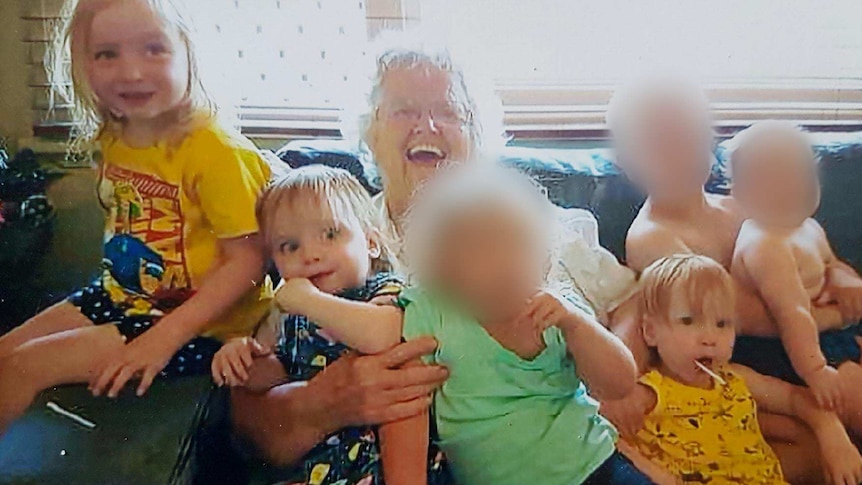 Beverley Quinn smiling with her grandchildren