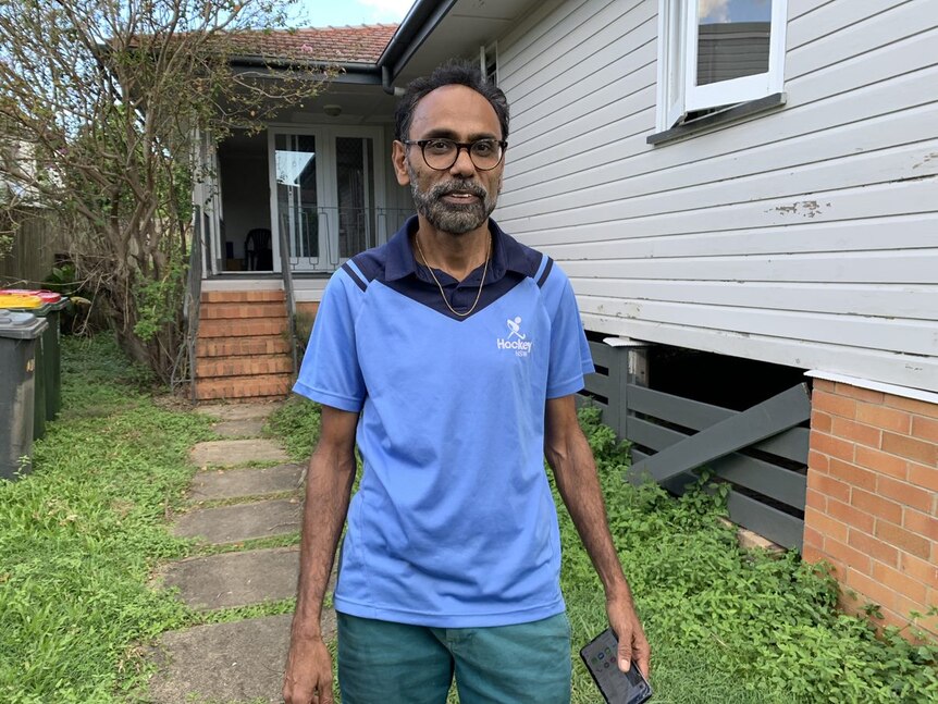 Atul Patel stands infront of his home. 