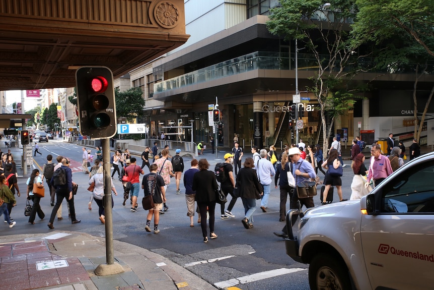 A busy Brisbane CBD scramble crossing at the intersection of Edward and Adelaide streets in March 2020, before coronavirus restrictions.