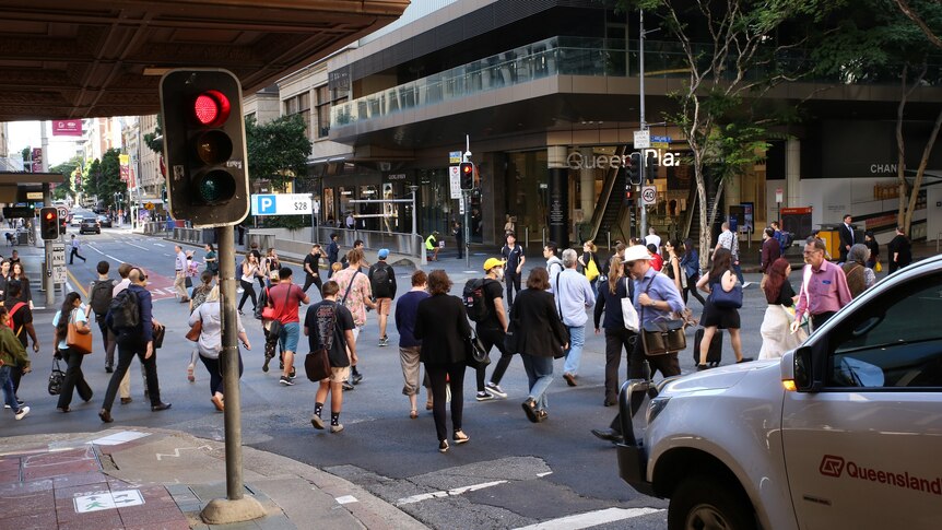 A busy Brisbane CBD scramble crossing at the intersection of Edward and Adelaide streets in March 2020.