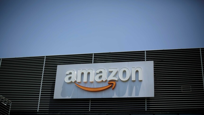 The logo of Amazon is seen on a building.