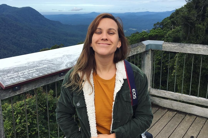 Nicolle White smiles for the camera while at a look out