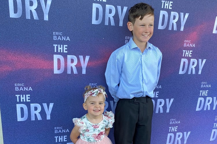 A young girl and a bigger boy pose for photos at the premiere of The Dry.