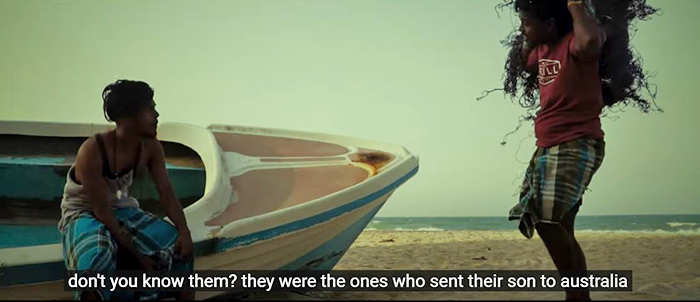 Two men on a beach talk about the plight of a family who tried to send their son to Australia. 