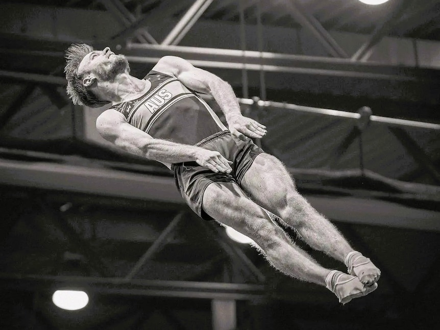 A male trampoline gymnast in the air.