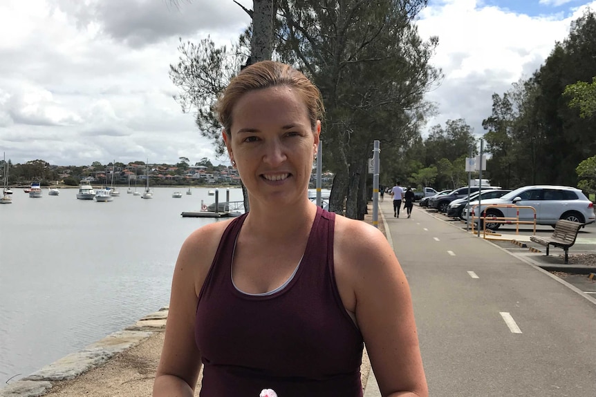 A woman stands beside The Bay Run at Lilyfield in Sydney's inner-west