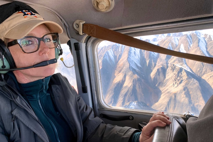 Zoe Daniel pictured with mountains outside the plane window.