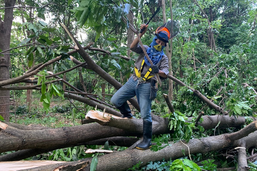 Achara on her farm with a machete.