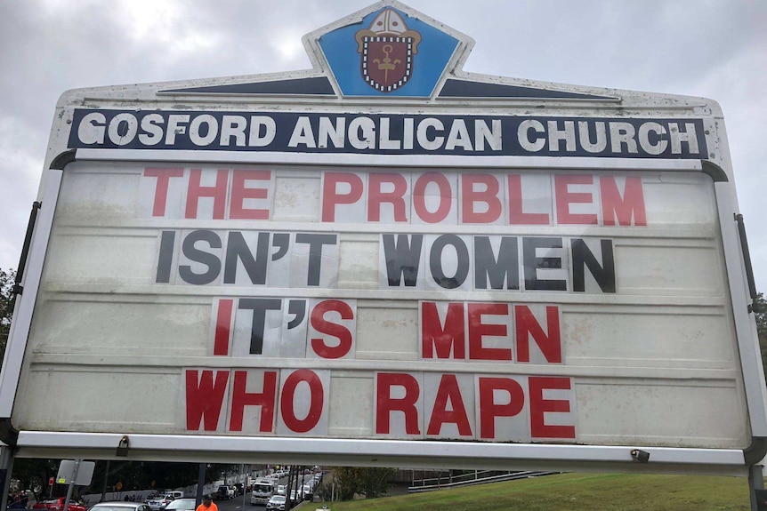 A sign reads, "The problem isn't women it's men who rape."
