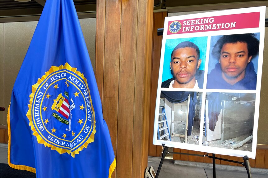 An FBI flag and a seeking information posterboard  the boared has two pictures of Negasi Zuberi and the cell