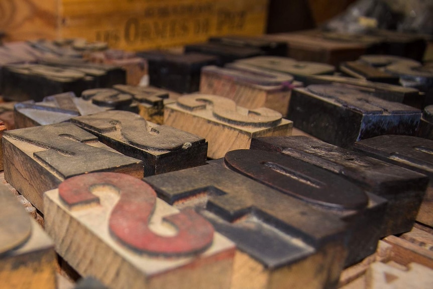 Close up of wooden printing press letters