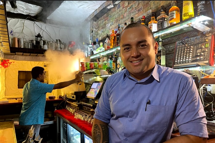 A photo of Julius Salato in front of a bar in Suva, Fiji. 