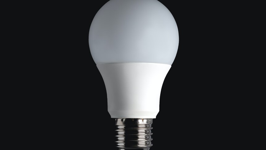 a loose lightbulb on a black background